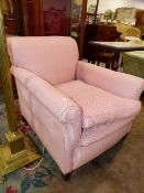 AN EDWARDIAN DEEP SEAT ARMCHAIR WITH FEATHER CUSHION ON SHORT SQUARE TAPERED LEGS.