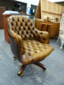 A BUTTON BACKED LEATHER SWIVEL DESK CHAIR ON COLUMN AND FOUR MAHOGANY STAINED LEGS ARRANGED IN X-