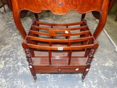 A MAHOGANY CANTERBURY, THE FOUR RACKS OVER A DRAWER AND BRASS CASTER FEET. W.51cms.