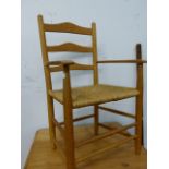 A GOOD HAND MADE CHILD'S ASH LADDER BACK CHAIR WITH RUSH SEAT.