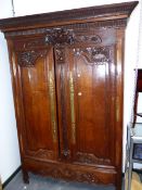 A 19th.C.FRENCH OAK TWO DOOR ARMOIRE WITH CARVED DECORATED PANELS AND BASE DRAWER. W.166 x D.56 x