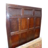 A 17th.C.AND LATER ADAPTED OAK TESTER BED WITH ELEVEN PANEL HEADBOARD AND TURNED COLUMN END SUPPORTS