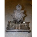 A METROPOLITAN POLICE BLACK PAINTED WOOD INKSTAND BACKED BY A CROWNED STAR WITH A J FOR THE