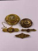 A GROUP OF FIVE ANTIQUE YELLOW METAL BROOCHES VARYING IN STYLE. TWO OF OVAL SHAPE, GLAZED BACK AND