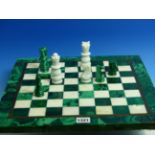 A MARBLE AND MALACHITE CHESS SET. THE KINGS. H 7.5cms WITH MATCHING BOARD. 40 x 40cms.