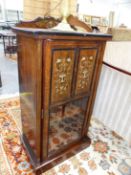 A LATE VICTORIAN INLAID ROSEWOOD MUSIC CABINET, THE TWO EBONY BORDERED PANELS TO THE UPPER HALF OF