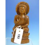 A CARVED WOOD BUDDHA SEATED CROSS LEGGED ON A DOUBLE LOTUS THRONE, HIS RIGHT HAND RAISED IN REFUGE