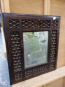 A RECTANGULAR MIRROR IN EGYPTIAN TASTE STAINED WOOD FRAME WITH MISHRABIYE TURNING ENCLOSED BY AN