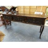 AN ANTIQUE CENTURY OAK DRESSER, THE THREE DRAWERS WITH GUILLOCHE CARVED FRONTS ABOVE CABRIOLE LEGS