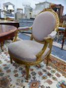 A PAIR OF FRENCH CARVED GILTWOOD LOUIS XVI STYLE SALON ARMCHAIRS WITH OVAL BACKS AND SHAPED SEATS ON
