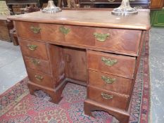 AN ANTIQUE CHILD'S MAHOGANY PEDESTAL DESK, THE LONG DRAWER ABOVE THE KNEEHOLE FLANKED BY THREE