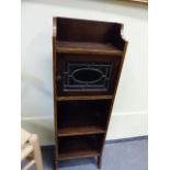 A SMALL OAK AND INLAID BOOKCASE WITH GLAZED SMALL CABINET OVER OPEN SHELVES IN THE MANNER OF