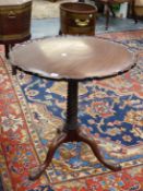 A GEO.III.MAHOGANY TRIPOD TABLE WITH TILTING PIE CRUST GALLERY TOP OVER SPIRAL TURNED COLUMN. Dia.71