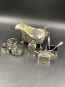 SILVER HALLMARKED ITEMS TO INCLUDE A THREE PART CRUET SET COMPLETE WITH BLUE GLASS LINERS, A