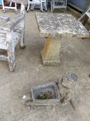 A SMALL SLAB TOP GARDEN TABLE AND A GARDEN ORNAMENT