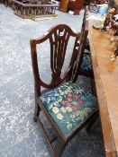 A SET OF SIX ANTIQUE FRUITWOOD FRAMED SHIELD BACKED DINING CHAIRS WITH DROP IN SEAT PADS.