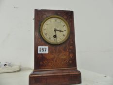 A FRENCH WOODEN MANTLE CLOCK.