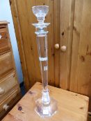A TALL GLASS CANDLE STICK