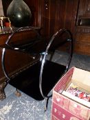 A RETRO TUBULAR CHROME AND BLACK GLASS TWO TIER TROLLEY