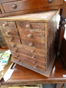A SMALL MULTI DRAWER CHEST.