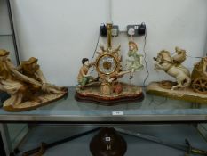 TWO ROYAL DUX FIGURINE GROUPS AND A LARGE PORCELAIN SET MANTLE CLOCK WITH CHILDREN ON A SEE SAW.