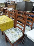 A SET OF SIX LADDER BACK CHAIRS.