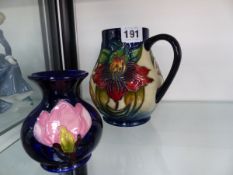 A MOORCROFT JUG AND A SMALL VASE.