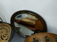 AN EDWARDIAN OVAL WALL MIRROR.