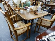 AN ERCOL ELM EXTENDING DINING TABLE AND SIX MATCHING CHAIRS.