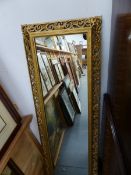 A GILT FRAMED MIRROR.