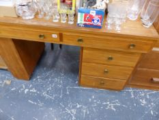 A MID CENTURY WALNUT DESK AND AN ARTS AND CRAFTS STYLE THREE TIER STAND.