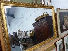 A LARGE GILT FRAMED MIRROR.