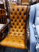 A LEATHER UPHOLSTERED ROCKING CHAIR.