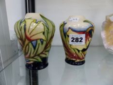 A PAIR OF MOORCROFT VASES.