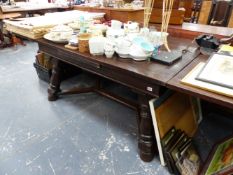 A LARGE OAK DRAW LEAF DINING TABLE.