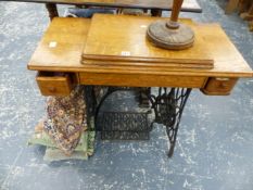 A TREADLE SWEWING MACHINE, CANDLESTAND, CUSHIONS AND A RUG.