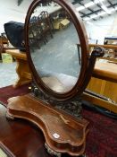 A VICTORIAN MAHOGANY SWING MIRROR.