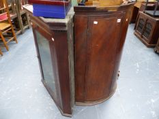 A GEORGIAN BOW FRONT CORNER CABINET AND A GEORGIAN MAHOGANY GLAZED CABINET.