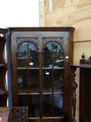 AN OAK CORNER CABINET.