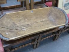 AN ANTIQUE WOODEN TRUG OR DOUGH BOWL.