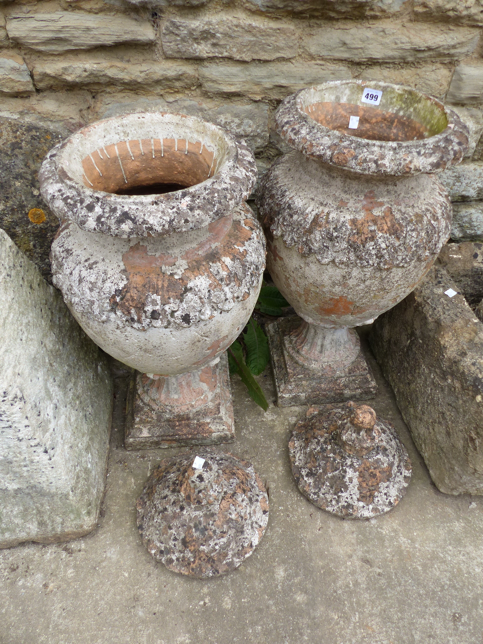 A PAIR OF ANTIQUE STYLE TERRACOTTA LIDDED URNS.