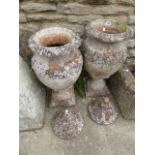 A PAIR OF ANTIQUE STYLE TERRACOTTA LIDDED URNS.
