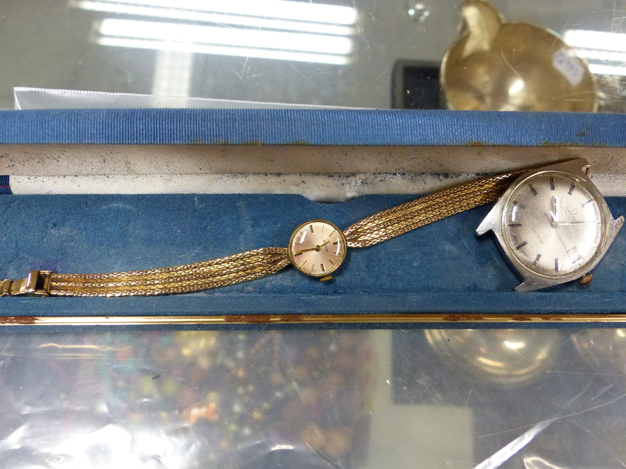 A LADIES 9ct GOLD BULOVA WATCH 17grms AND A GENTS OMEGA WATCH (HEAD ONLY).