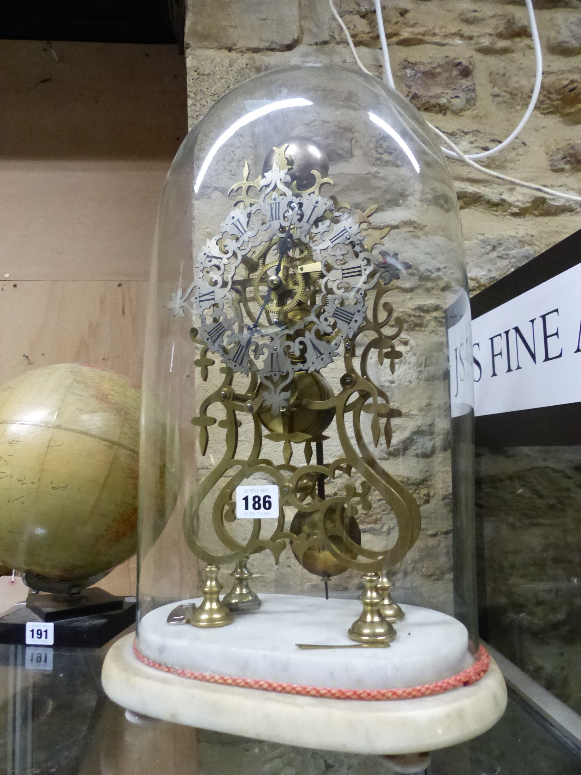 A VICTORIAN SKELETON FUSEE CLOCK UNDER GLASS DOME ON MARBLE BASE.