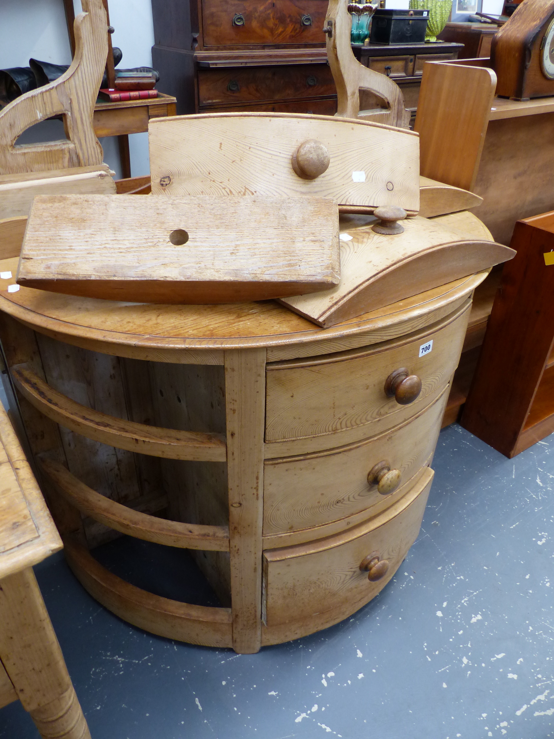 A BOW FRONT PINE THREE DRAWER CHEST.