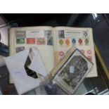 A STAMP ALBUM AND AN ASSORTMENT OF POSTCARDS.