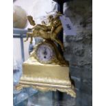 A VICTORIAN ORMOLU CASED MANTLE CLOCK WITH SILVER DIAL.