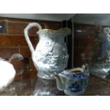 A JONES AND WALLEY GYPSY MOLDED STONEWARE JUG AND A MINIATURE BLUE AND WHITE TEAPOT.