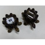 A PAIR OF SERDAR GULGUN BRONZE TORTOISES WITH HARDSTONE ACCENTS AND A MAGNIFYING GLASS BACK.