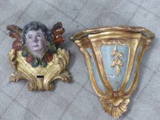 A PAIR OF CARVED AND GILDED WALL BRACKETS.